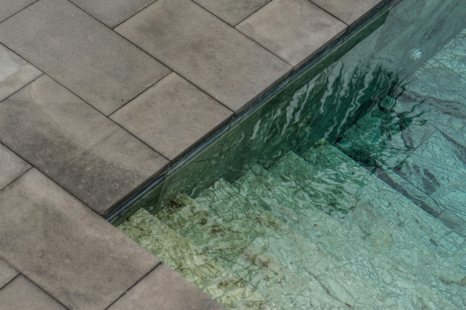 premium solid safety cover with reinforced anchors being carried out at a residential pool deck in North York, Ontario
